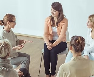 Adults in a group therapy discussion